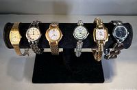 All six watches displayed on stand