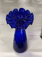 Front view showing cobalt blue vase and flared ruffle rim