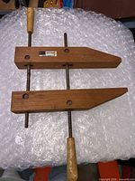 Overall view of wooden hand screw clamp showing jaws, screws, and handles