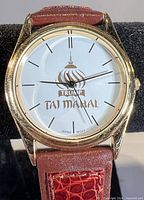 Front view showing dial with Trump Taj Mahal logo and gold-tone case