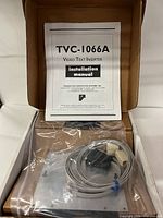 Box opened showing manual, sealed device and accessories