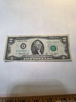 Front of $2 bill showing portrait, serial number, seal, signatures