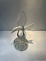 Front view of clear glass seagull flower frog