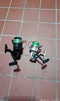 Both spinning reels side by side on tiled floor