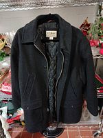 Front view of wool coat showing zipper, pockets and overall condition