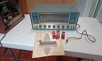 Front view of Lafayette HE-80 receiver with manual and RCA tube boxes on table