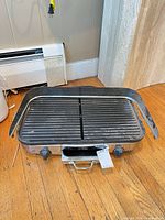 Full view of All-Clad electric grill with splash guard attached on three sides