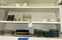 Cabinet shelves showing Lenox pitcher, ramekins, bowls, plates, teal dishes