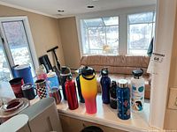 Group shot of all assorted water bottles on counter