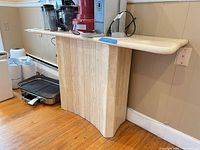 Full view of console table against wall showing curved panel base and stone top