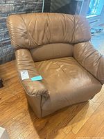 Front view of tan faux leather barrel armchair