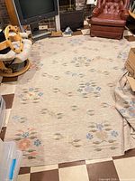 Entire large rug spread on floor showing pattern and wear
