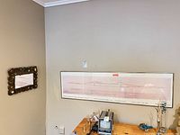 Wall view showing both the framed print and stone-framed mirror