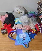 Group shot of all stuffed animals and dolls on floor