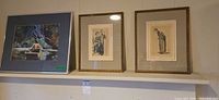 Overall view of all three framed prints on shelf