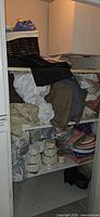 Closet shelves with mixed linens, paper goods, decorative boxes, baskets