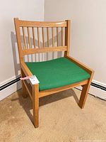 Full view of chair showing slat back and green seat