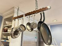 Overall view of pot rack with pans hanging