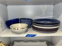 Plates and bowls on shelf showing variety and counts