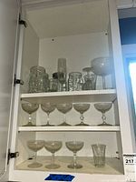 Cabinet view showing all glassware on three shelves