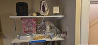Shelf with boxed Wilton castle set, aluminum pans, hand vacuum, heater, storage case
