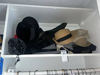 Shelf showing multiple hats of different materials and styles