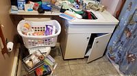 Overview showing basket of tapes/bandages, pill organizers, vanity with assorted supplies