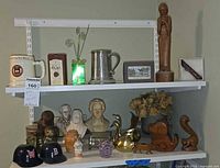 Two shelves showing majority of mixed collectibles