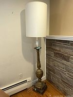 Full view of brass floor lamp with shade in room
