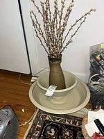 Pitcher with stems placed inside bowl and platter