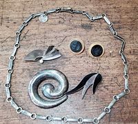 All five jewelry pieces laid out