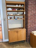 Front view showing full height shelves and cabinet