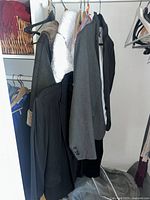 Multiple blazers and coats hanging in closet