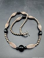 Full view of long sterling silver and onyx bead necklace