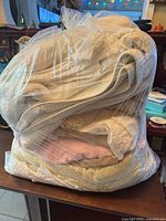 Large clear bag filled with folded linens
