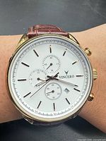 Watch on wrist showing dial details and gold-tone case