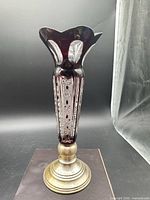 Full view of ruby red cut-to-clear crystal vase on sterling silver base