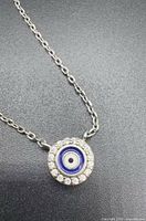 Front view of necklace showing evil eye pendant with clear stone halo