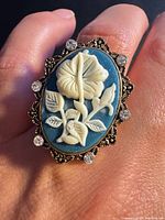 Ring on finger showing full cameo and rhinestones