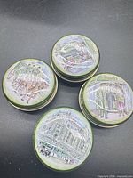 Four illustrated Harrods tins, closed view