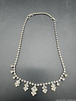 Full view of necklace laid flat showing overall design and clasp