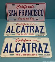 Front view of all three plates: San Francisco plate above two Alcatraz plates