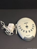 Front view of Conair sound therapy machine and AC adapter