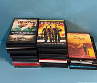 Stacked view showing multiple DVD cases; top cases 'We Are Marshall', 'Stealth', 'What Dreams May Come' visible