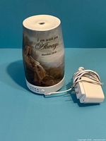 Front view of porcelain diffuser showing artwork, verse, and power adapter