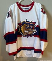Front view of Hamilton Bulldogs jersey on hanger