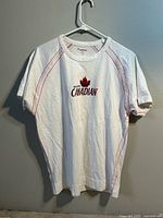 Full front view of white Molson Canadian logo T-shirt on hanger