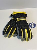 Pair of Nandn black/yellow ski gloves with tag front view