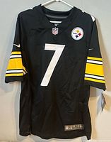 Front view of jersey on hanger showing number 7, Steelers logo patch, size and tag