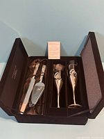 Set inside presentation box showing knife, server, flutes, and card